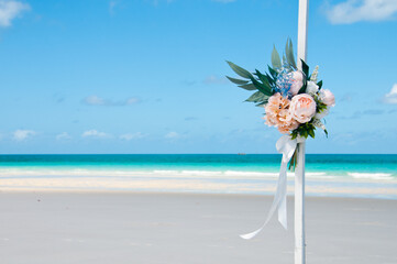 Flower bouquet at peaceful serene scene of vast white sandy beach in Hamilton Island Queensland...