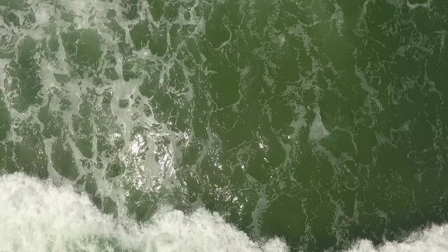 Downward angle drone shot of ocean waves in North Carolina