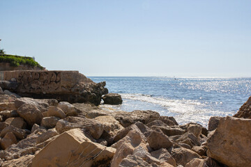 Fototapeta na wymiar A beautiful view of the mediterranean sea with large stones in the foreground. Campello, Spain