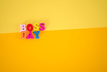 National Happy Boss Day. Multicolored letters on a yellow blank piece of paper.