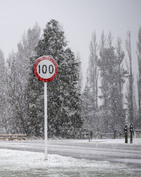 Traffic Sign In A Snow Storm, South Island. Vertical Format.