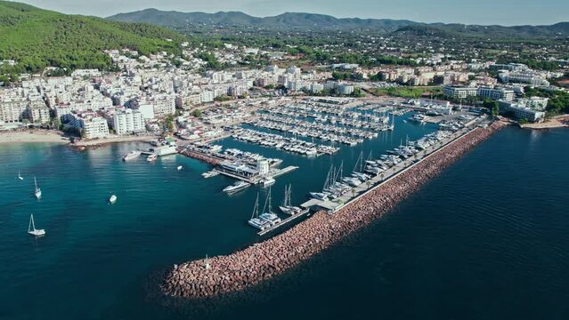 Beautiful view of Port de Santa Eul&agrave;ria des Riu with many vessels in Ibiza. Aerial view of Playa De Santa Eulalia beach by the harbour with coastal resorts and hotels on Balearic Islands, Spain.