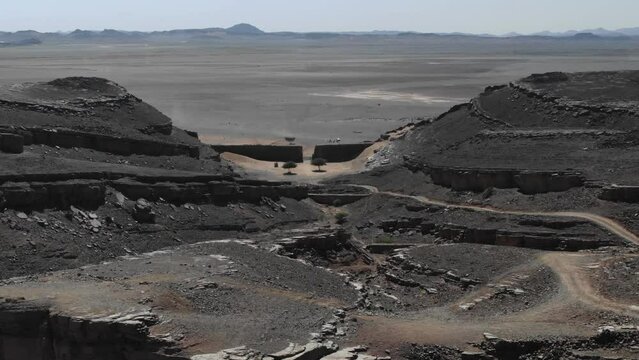 Aerial drone panoramic view of Gara Medouar horseshoe shaped geological formation due to meteorite crater in Morocco desert, Africa