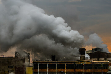 Old factory polluting the atmosphere with toxic smoke and smog