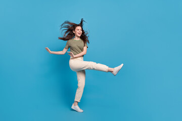 Fototapeta na wymiar Full size photo of cute young brunette lady dance wear casual cloth isolated on blue background