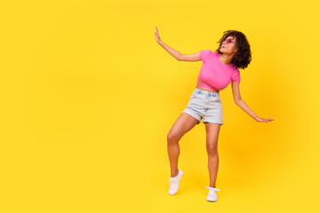 Fototapeta na wymiar Full body portrait of excited positive girl dancing spend free time clubbing isolated on yellow color background