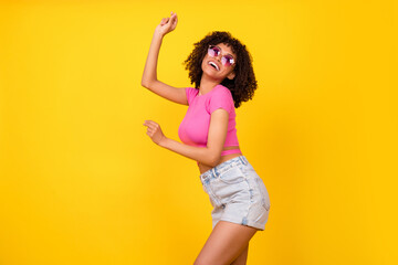 Photo of gorgeous excited crazy girl enjoy dancing clubbing have fun isolated on yellow color background