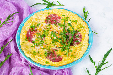 Omelette with sausage, herbs and grated cheese. Easy breakfast