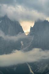 Close up of mountains hidden in fog at Sunrise of Alp De Suisi, Dolomites, Italy