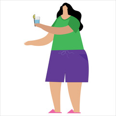 A woman holds a glass of water with lemon in her hand