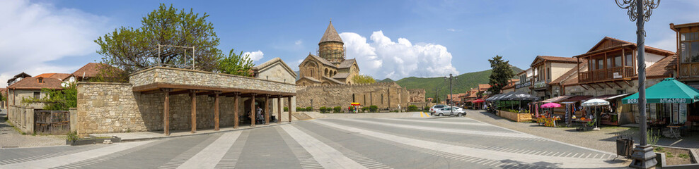 Fototapeta na wymiar Svetitskhoveli Cathedral and a square nearby with restaurants, Mtskheta, Georgia