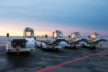 Airport self-propelled conveyor belt loaders at the evening