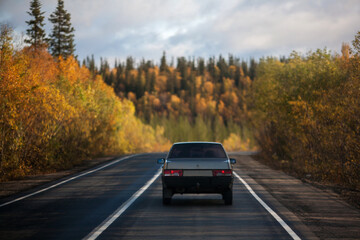 Driving car on the way to Autumn forest in Russia