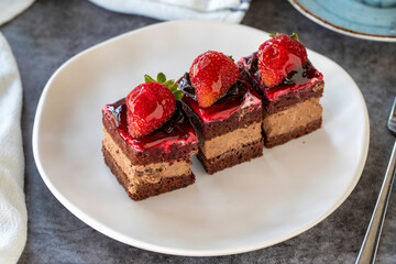 Strawberry tartlet. Small strawberry cake in a plate. On dark floor. close up