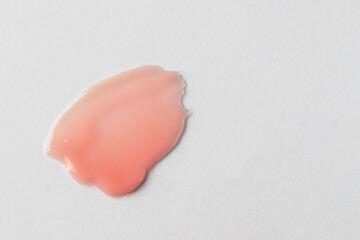 Cosmetic products swatch. Creamy pink texture smear on white background.