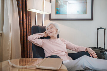Short-haired elegant senior lady in a hotel room