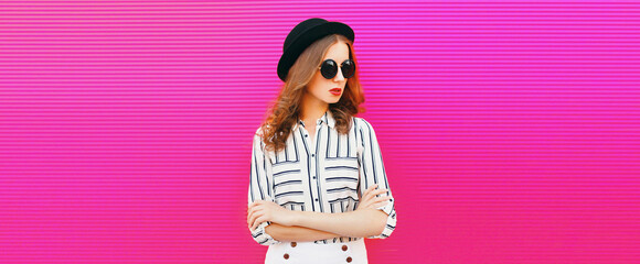 Portrait of beautiful woman model wearing summer hat, white striped shirt on pink background