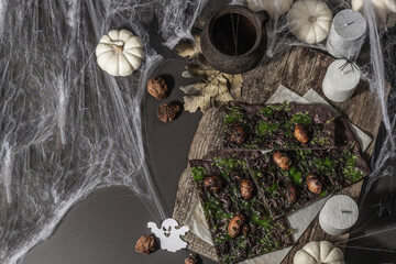 Halloween concept food. Flatbread or pizza with squid Ink, green cheese, mushrooms and purple onion