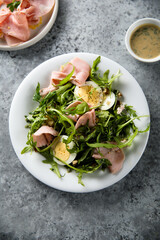 Arugula salad with ham and egg