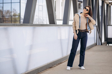 Young woman in casual wear posing in the street