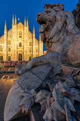 Sunset Scene of The ornate gothic facade, soaring spires and magnificent marble towers of the Duomo, Milan's monumental cathedral under big blue Lombardy skies - 522236941