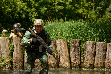 Soldiers game on military training ground battle camp. Action. Operation Trainer giving training to...