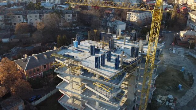 aerial view of construction site of monolithic buildings. Workers work at construction site reinforced concrete structures. Modern industrial monolithic construction