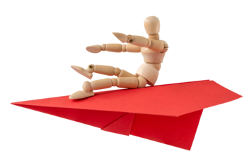 Wooden man flying on a paper plane