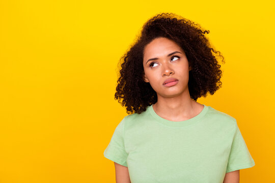 Photo of bored upset lady wear green t-shirt looking empty space isolated yellow color background
