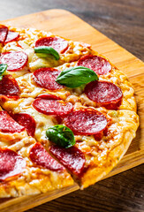 Fototapeta Pepperoni Pizza with cheese, salami, Tomato sauce, pepper, Spices. Italian pizza on wooden background obraz