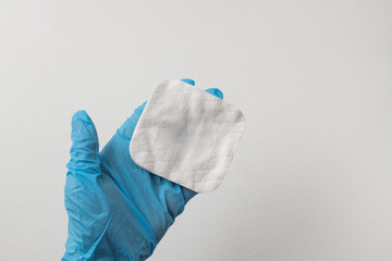 hadn holding white cotton sponges on white background. Design for the beauty, medicine and cosmetics industry