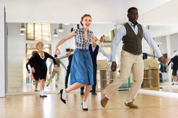 Obraz premium Woman with african man practising charleston dancing