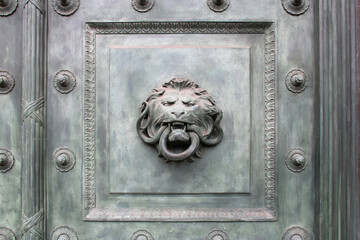 old bronze door with knocker in paris (france)