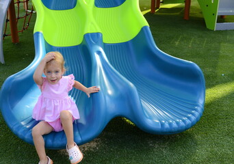 Little girl 2 years old on the playground. Baby plays in kindergarten