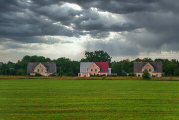 Fototapeta na wymiar Abandoned village. Three houses in the meadow.