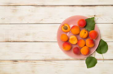 Fototapeta na wymiar Composition with ripe apricots on wooden background, top view