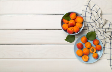 Composition with ripe apricots on wooden background, top view