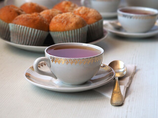 Obraz na płótnie Canvas Cup of tea, teaspoon, and cupcake