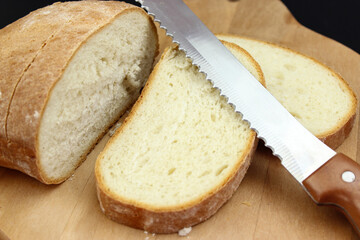 Seed bread, homemade bread,cutting bread. Cut fresh bread with a knife.