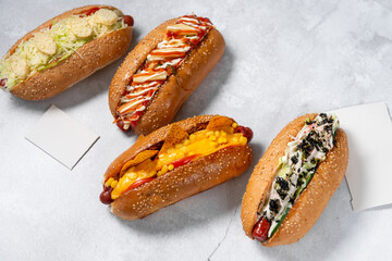 Fast food hot dog banner on a light grey stone textured background, hotdog menu template, hotdog menu mock up, free space for text, different hot dog types