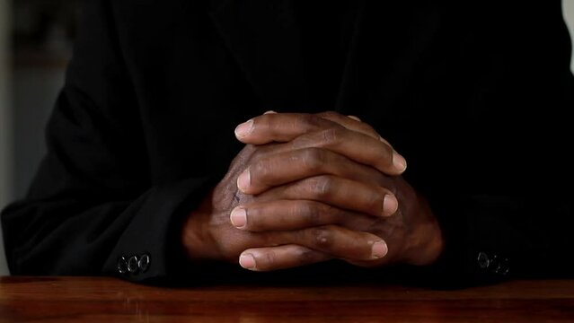 man praying to god with hands together on black background stock footage