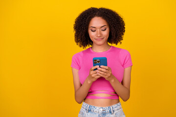 Photo of nice brunette millennial lady look telephone wear pink top isolated on vivid orange color background