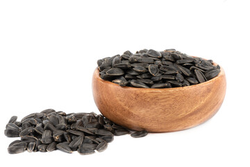 Unpeeled sunflower seeds on a white background.