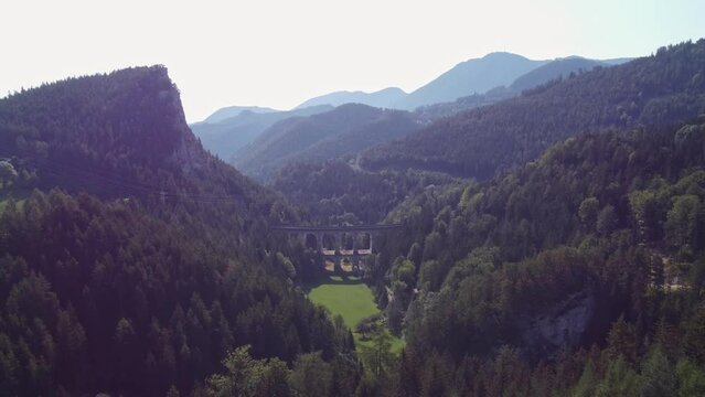 View of the Kalte-Rinne-Viadukt on the Semmeringbahn in Styria, Austria. Beautiful stone bridge for train. Historical piece of the village of Breitenstein, Steiermark. 4k video
