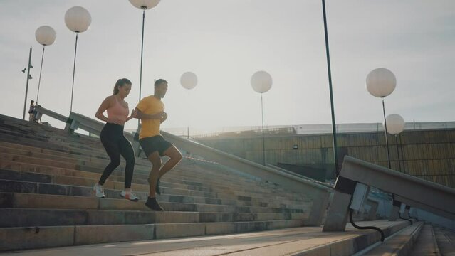 Cinematic video of urban runners athletes training outdoor in a modern part of the city. Concept about sport and healthy lifestyle