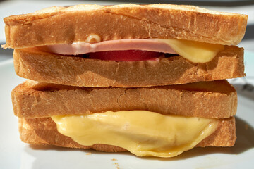 Hot sandwich with fried bread, cheese and sausage.