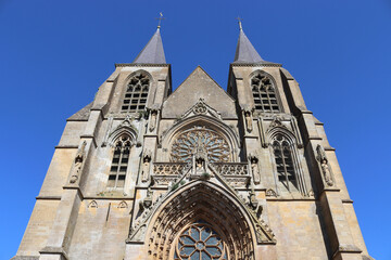 Beautiful view of the exterior facade of the gothic style Basilica of Notre Dame of Avioth. Located in the region of Grand Est France, summer view with clear sky.