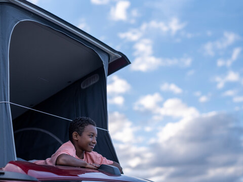 Boy (8-9) In Camper Van Rooftop Tent