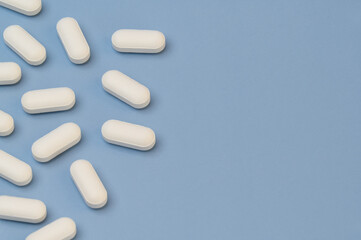 Vitamins tablets supplements on Blue background