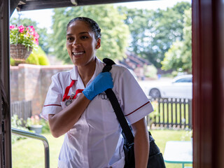 Portrait of nurse standing in doorway